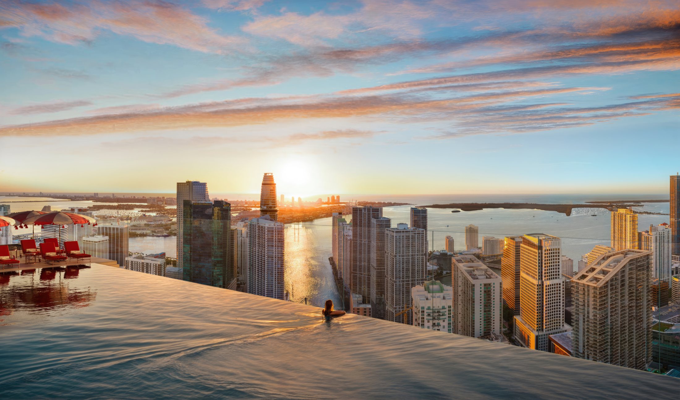 Faena Residences Miami rooftop infinity pool over the Miami River at sunset